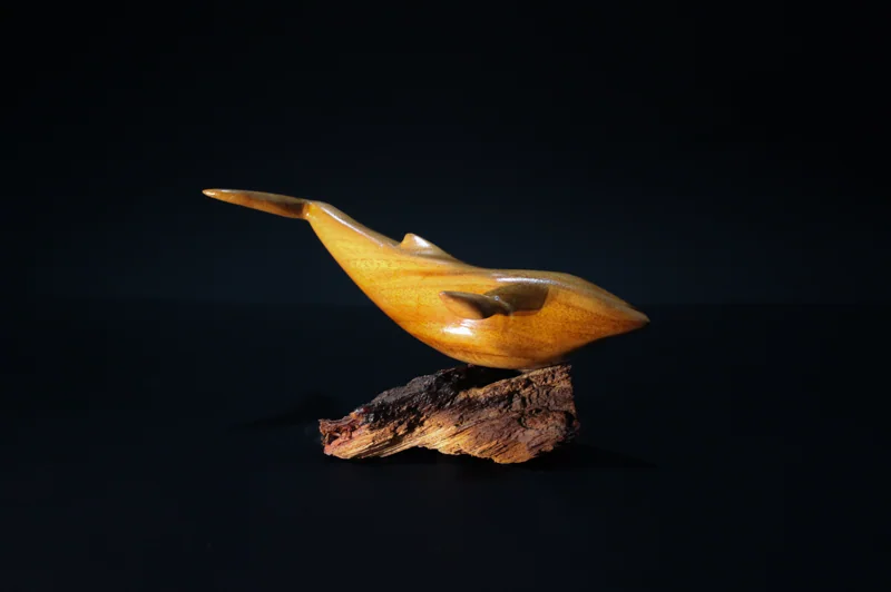 A hand carved whale from teak wood
